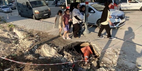 İnşaat çevresindeki kaldırımda oluşan derin göçükler muhtemel kazalara davetiye çıkarıyor